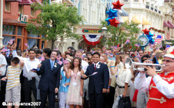 Walt Disney World Ambassadors escort the new citizens down Main Street USA.
