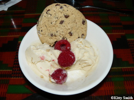 Vanilla soy ice cream with raspberries and a vegan chocolate chip cookie