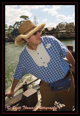 Cast Member Anthony pilots a raft from Tom Sawyer Island back to the Magic Kingdom, Walt Disney World, Orlando, Florida.
