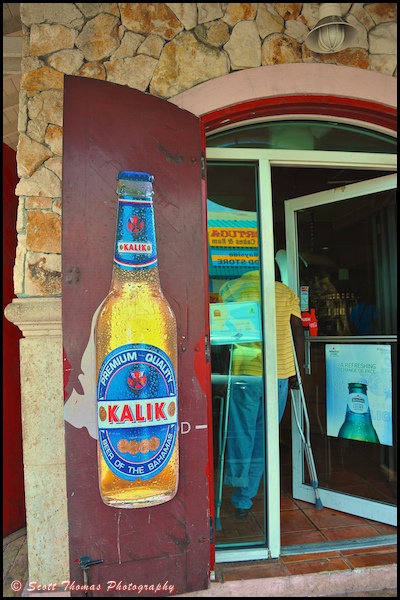 Advertising sign for Kalik beer, the official beer of the Bahamas, on a shop door in Nassau, Bahamas