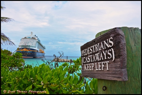 A sign on Castaway Cay with the Disney Dream cruise ship in the background.