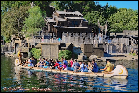 Guests paddling a Davy Crockett Explorer Canoe on the Rivers of America at Disneyland in Anaheim, California