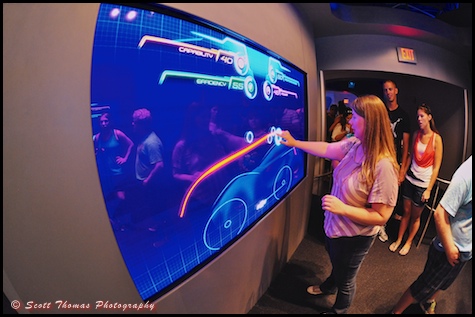 A young woman designing a car in the queue for Test Track in Epcot's Future World, Walt Disney World, Orlando, Florida
