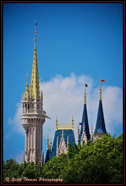 Spires and towers of Cinderella Castle poke above trees in the Magic Kingdom, Walt Disney World, Orlando, Florida