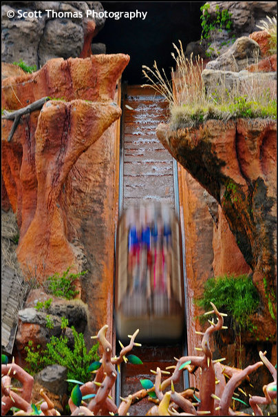 Guests drop down the Splash Mountain waterfall in the Magic Kingdom, Walt Disney World, Orlando, Florida