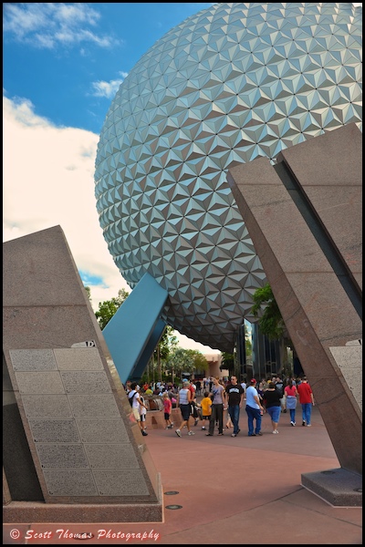 Guests are framed between Leave A Legacy structures near Spaceship Earth in Epcot, Walt Disney World, Orlando, Florida