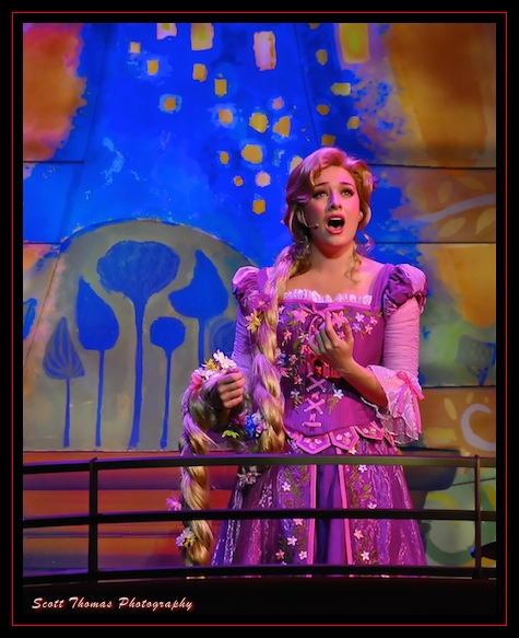 Rapunzel singing from the balcony in The Golden Mickeys in the Walt Disney Theatre on the Disney Dream cruise ship.