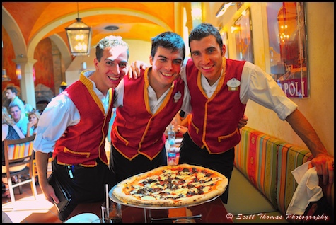 Servers posing with a creation from the Via Napoli chefs in Epcot's Italy pavillion, Walt Disney World, Orlando, Florida.